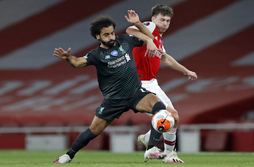 Liverpool's Egyptian midfielder Mohamed Salah (L) vies with Arsenal's Scottish defender Kieran Tierney (R) during the English Premier League football match between Arsenal and Liverpool at the Emirates Stadium in London on July 15, 2020. (Photo by PAUL CHILDS / POOL / AFP) / RESTRICTED TO EDITORIAL USE. No use with unauthorized audio, video, data, fixture lists, club/league logos or 'live' services. Online in-match use limited to 120 images. An additional 40 images may be used in extra time. No video emulation. Social media in-match use limited to 120 images. An additional 40 images may be used in extra time. No use in betting publications, games or single club/league/player publications. / (Photo by PAUL CHILDS/POOL/AFP via Getty Images)