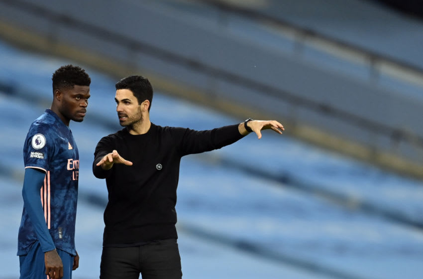 Arsenal's Ghanaian midfielder Thomas Partey (L) receives directions from Arsenal's Spanish manager Mikel Arteta during the English Premier League football match between Manchester City and Arsenal at the Etihad Stadium in Manchester, north west England, on October 17, 2020. (Photo by Michael Regan / POOL / AFP) / RESTRICTED TO EDITORIAL USE. No use with unauthorized audio, video, data, fixture lists, club/league logos or 'live' services. Online in-match use limited to 120 images. An additional 40 images may be used in extra time. No video emulation. Social media in-match use limited to 120 images. An additional 40 images may be used in extra time. No use in betting publications, games or single club/league/player publications. / (Photo by MICHAEL REGAN/POOL/AFP via Getty Images)