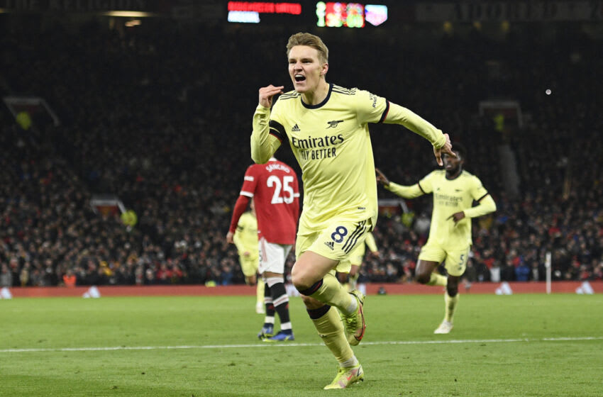 Arsenal's Norwegian midfielder Martin Odegaard celebrates after scoring their second goal during the English Premier League football match between Manchester United and Arsenal at Old Trafford in Manchester, north west England, on December 2, 2021. - RESTRICTED TO EDITORIAL USE. No use with unauthorized audio, video, data, fixture lists, club/league logos or 'live' services. Online in-match use limited to 120 images. An additional 40 images may be used in extra time. No video emulation. Social media in-match use limited to 120 images. An additional 40 images may be used in extra time. No use in betting publications, games or single club/league/player publications. (Photo by Oli SCARFF / AFP) / RESTRICTED TO EDITORIAL USE. No use with unauthorized audio, video, data, fixture lists, club/league logos or 'live' services. Online in-match use limited to 120 images. An additional 40 images may be used in extra time. No video emulation. Social media in-match use limited to 120 images. An additional 40 images may be used in extra time. No use in betting publications, games or single club/league/player publications. / RESTRICTED TO EDITORIAL USE. No use with unauthorized audio, video, data, fixture lists, club/league logos or 'live' services. Online in-match use limited to 120 images. An additional 40 images may be used in extra time. No video emulation. Social media in-match use limited to 120 images. An additional 40 images may be used in extra time. No use in betting publications, games or single club/league/player publications. (Photo by OLI SCARFF/AFP via Getty Images)