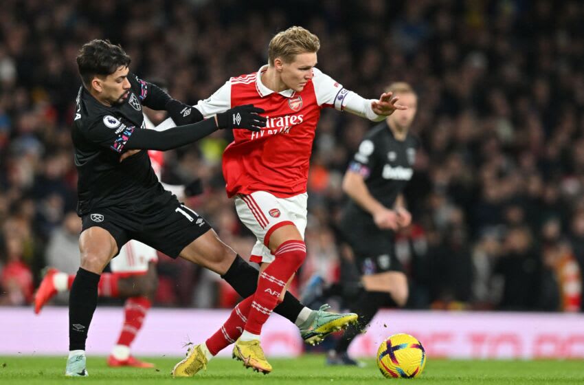West Ham United's Brazilian midfielder Lucas Paqueta (L) fights for the ball with Arsenal's Norwegian midfielder Martin Odegaard during the English Premier League football match between Arsenal and West Ham United at the Emirates Stadium in London on December 26, 2022. - - RESTRICTED TO EDITORIAL USE. No use with unauthorized audio, video, data, fixture lists, club/league logos or 'live' services. Online in-match use limited to 120 images. An additional 40 images may be used in extra time. No video emulation. Social media in-match use limited to 120 images. An additional 40 images may be used in extra time. No use in betting publications, games or single club/league/player publications. (Photo by Glyn KIRK / AFP) / RESTRICTED TO EDITORIAL USE. No use with unauthorized audio, video, data, fixture lists, club/league logos or 'live' services. Online in-match use limited to 120 images. An additional 40 images may be used in extra time. No video emulation. Social media in-match use limited to 120 images. An additional 40 images may be used in extra time. No use in betting publications, games or single club/league/player publications. / RESTRICTED TO EDITORIAL USE. No use with unauthorized audio, video, data, fixture lists, club/league logos or 'live' services. Online in-match use limited to 120 images. An additional 40 images may be used in extra time. No video emulation. Social media in-match use limited to 120 images. An additional 40 images may be used in extra time. No use in betting publications, games or single club/league/player publications. (Photo by GLYN KIRK/AFP via Getty Images)