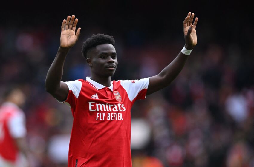Arsenal's English midfielder Bukayo Saka gestures to fans on the pitch after the English Premier League football match between Arsenal and Crystal Palace at the Emirates Stadium in London on March 19, 2023. - Arsenal won the game 4-1. (Photo by JUSTIN TALLIS / AFP) / RESTRICTED TO EDITORIAL USE. No use with unauthorized audio, video, data, fixture lists, club/league logos or 'live' services. Online in-match use limited to 120 images. An additional 40 images may be used in extra time. No video emulation. Social media in-match use limited to 120 images. An additional 40 images may be used in extra time. No use in betting publications, games or single club/league/player publications. / (Photo by JUSTIN TALLIS/AFP via Getty Images)