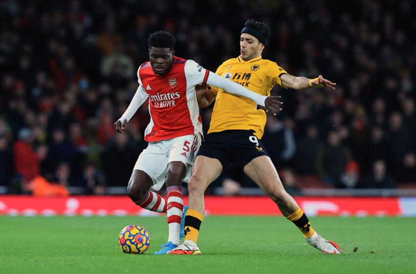 LONDON, ENGLAND - FEBRUARY 24: Thomas Partey of Arsenal is tackled by Raul Jimenez of Wolverhampton Wanderers during the Premier League match between Arsenal and Wolverhampton Wanderers at Emirates Stadium on February 24, 2022 in London, England. (Photo by David Rogers/Getty Images)
