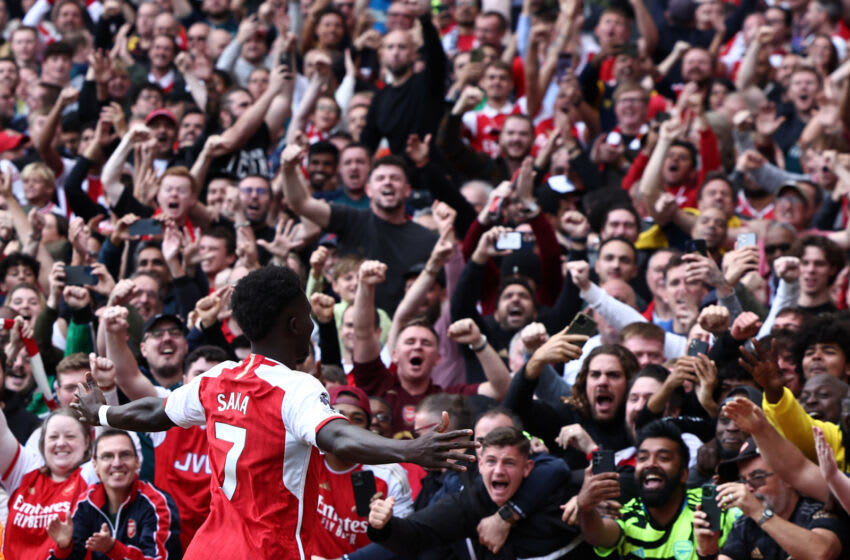 Arsenal's English midfielder #07 Bukayo Saka celebrates with supporters after scoring their second goal from the penalty spot during the English Premier League football match between Arsenal and Tottenham Hotspur at the Emirates Stadium in London on September 24, 2023. (Photo by HENRY NICHOLLS / AFP) / RESTRICTED TO EDITORIAL USE. No use with unauthorized audio, video, data, fixture lists, club/league logos or 'live' services. Online in-match use limited to 120 images. An additional 40 images may be used in extra time. No video emulation. Social media in-match use limited to 120 images. An additional 40 images may be used in extra time. No use in betting publications, games or single club/league/player publications. / (Photo by HENRY NICHOLLS/AFP via Getty Images)