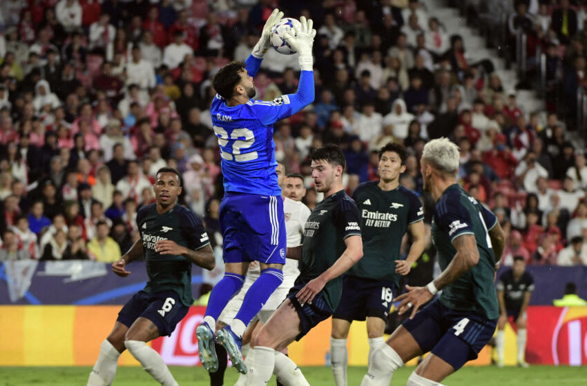 Arsenal's Spanish goalkeeper #22 David Raya jumps to make a save during the UEFA Champions League 1st round day 3 Group B football match between Sevilla FC and Arsenal at the Ramon Sanchez Pizjuan stadium in Seville on October 24, 2023. (Photo by CRISTINA QUICLER / AFP) (Photo by CRISTINA QUICLER/AFP via Getty Images)